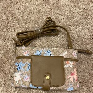 Multi-colored travel clutch with adjustable crossbody strap